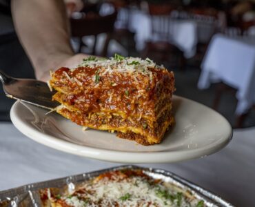 A slice of lasagna being plated